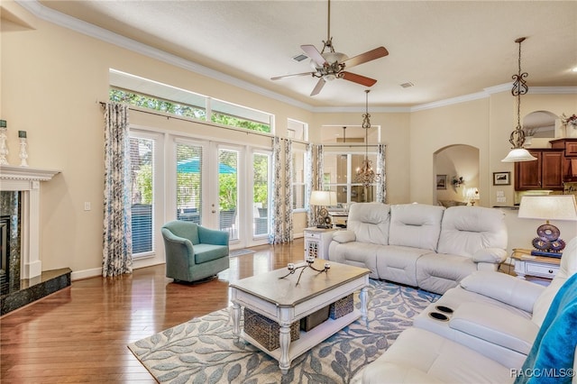 1993 N Eagle Chase Dr, Hernando, FL 34442 - living room with ceiling fan, a high end fireplace, arched walkways, hardwood / wood-style flooring, and ornamental molding