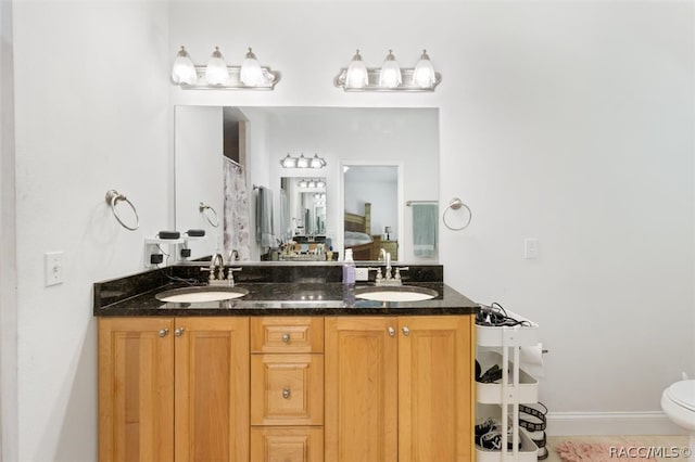 bathroom with tile patterned floors, vanity, and toilet