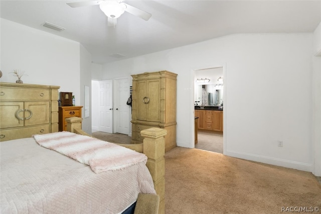 carpeted bedroom featuring ensuite bath, ceiling fan, and lofted ceiling