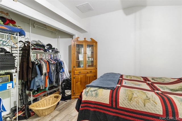 bedroom featuring light wood-type flooring and a closet