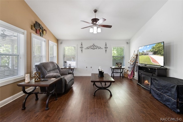 living room featuring vaulted ceiling, ceiling fan, and dark hardwood / wood-style floors