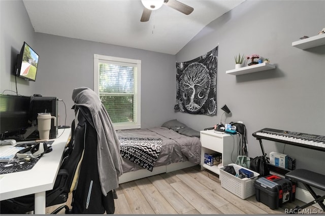 bedroom with ceiling fan, light wood-type flooring, and lofted ceiling