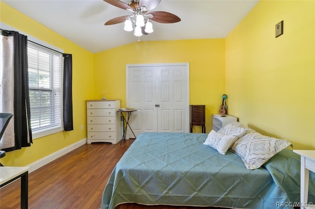 bedroom featuring ceiling fan, vaulted ceiling, dark wood-type flooring, and a closet