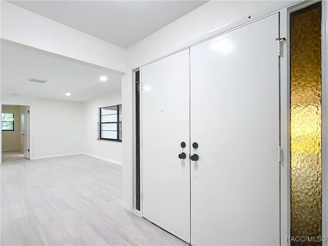 foyer entrance with light hardwood / wood-style floors