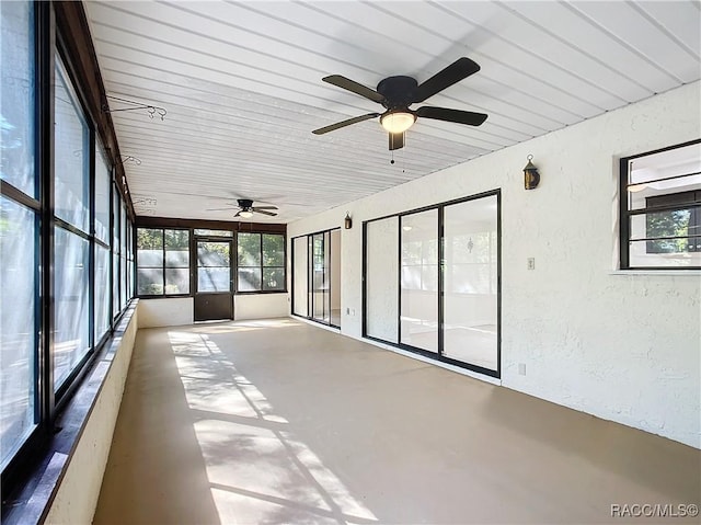 unfurnished sunroom featuring ceiling fan and wooden ceiling