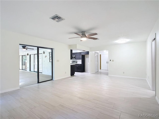 unfurnished living room featuring ceiling fan and hardwood / wood-style floors