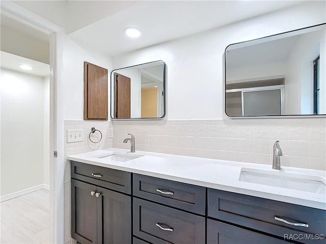 bathroom with decorative backsplash and vanity