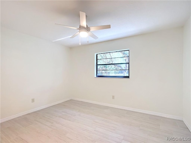 spare room featuring light hardwood / wood-style flooring and ceiling fan