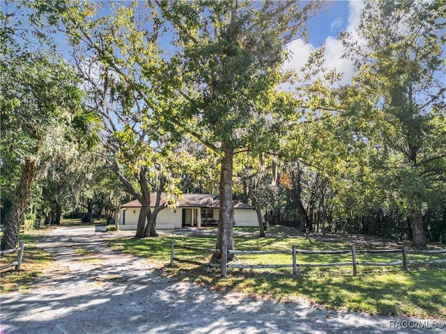 view of front of property with a front yard and a garage