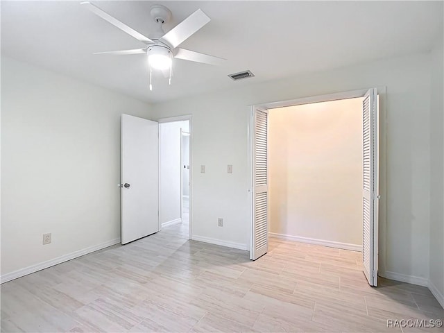 unfurnished bedroom with a closet and ceiling fan