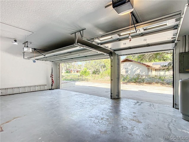 garage featuring electric panel and a garage door opener