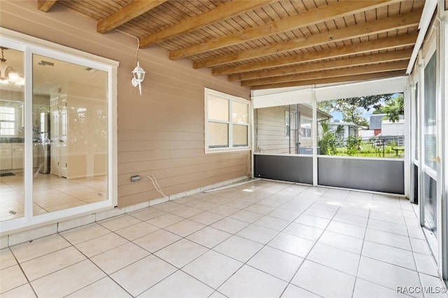 unfurnished sunroom with beamed ceiling and wooden ceiling