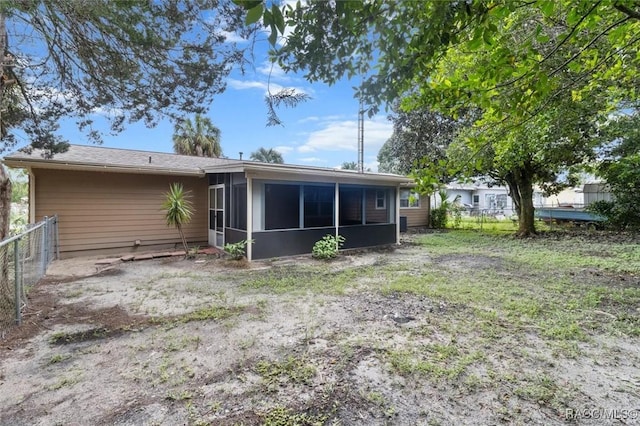 back of property with a sunroom