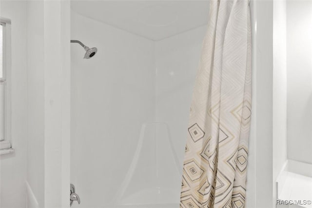 interior details featuring a shower with curtain