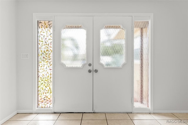 doorway featuring light tile patterned flooring and french doors