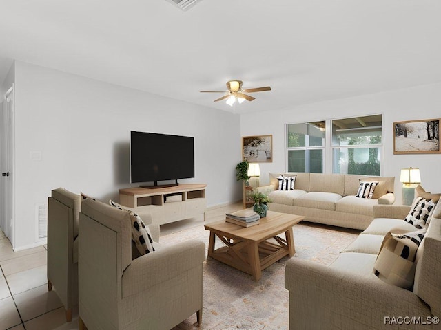 living room featuring light tile patterned floors and ceiling fan