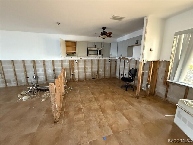 interior space featuring gray cabinets and ceiling fan