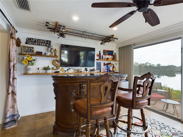 bar with crown molding and dark tile patterned floors