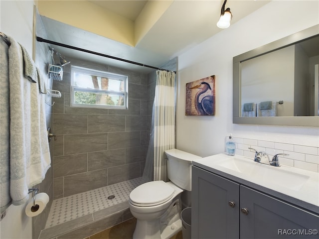 bathroom featuring vanity, toilet, curtained shower, and decorative backsplash