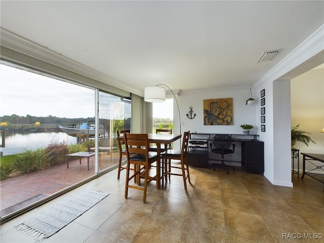 dining room with crown molding and a water view