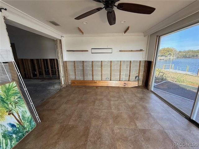 empty room featuring ornamental molding and a water view