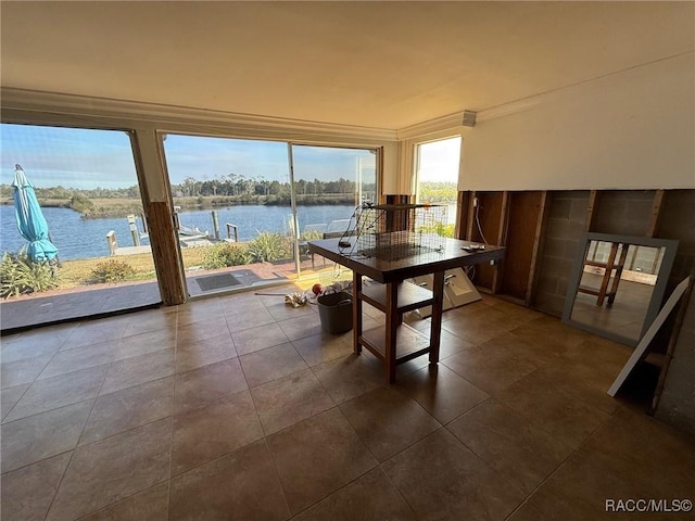 sunroom / solarium with a water view