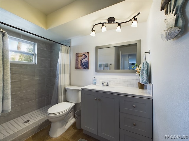 bathroom with vanity, decorative backsplash, a shower with curtain, and toilet