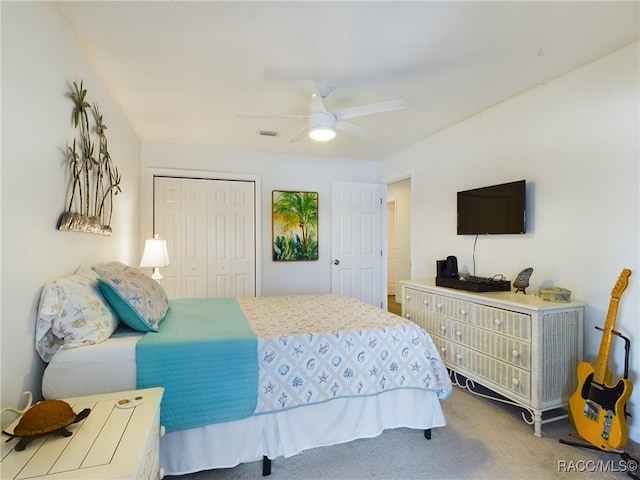 bedroom with carpet floors, ceiling fan, and a closet