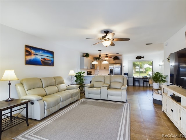 tiled living room featuring ceiling fan