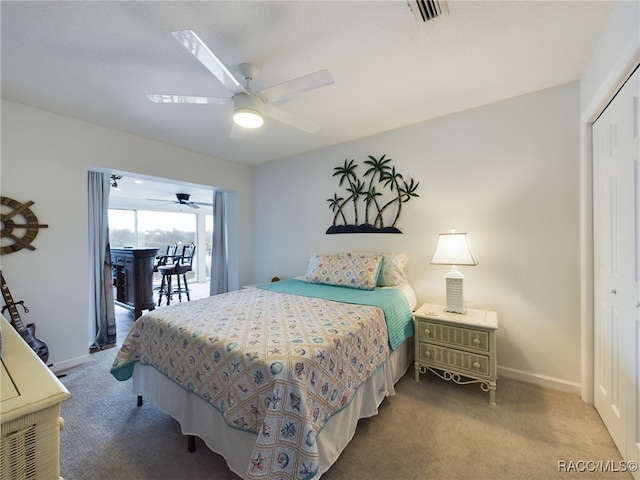 bedroom featuring access to exterior, a closet, ceiling fan, and carpet flooring