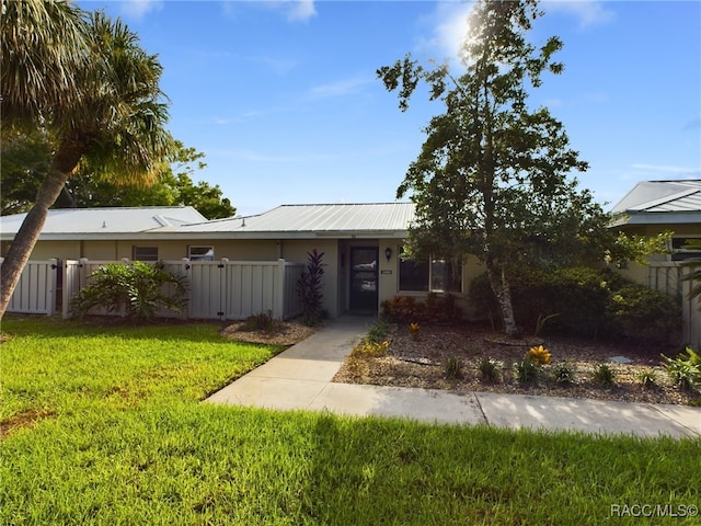 ranch-style house with a front lawn