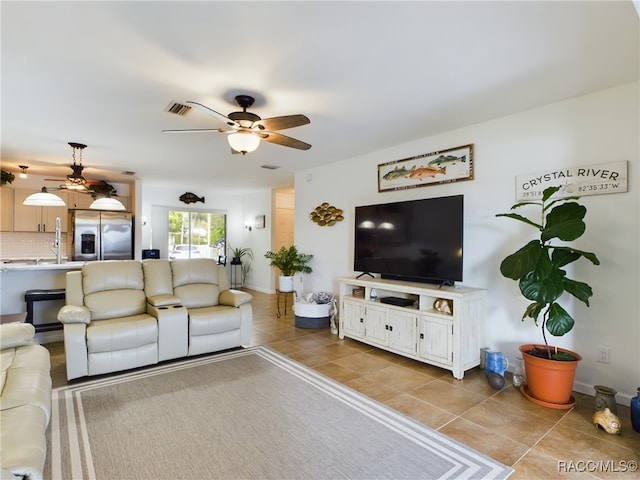 living room with light tile patterned floors and ceiling fan