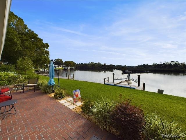 view of patio / terrace with a boat dock and a water view