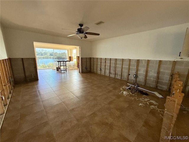 spare room with ceiling fan and tile patterned flooring