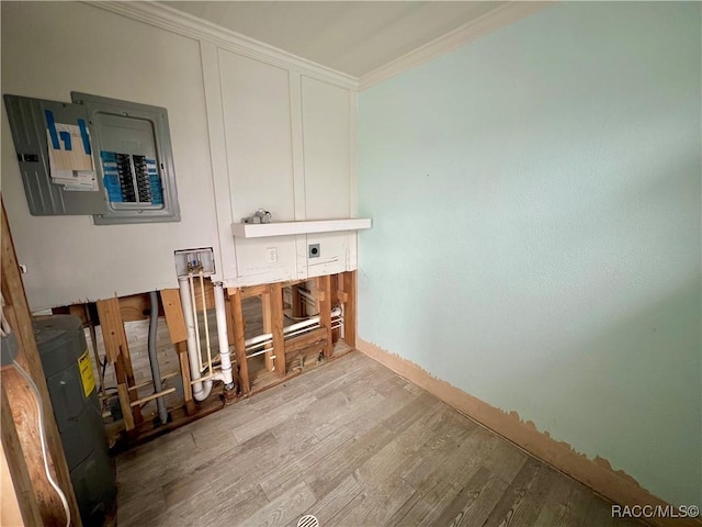 washroom with ornamental molding, light hardwood / wood-style flooring, and electric panel