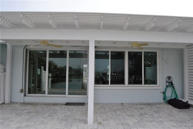 exterior space featuring ceiling fan, a patio area, and a pergola