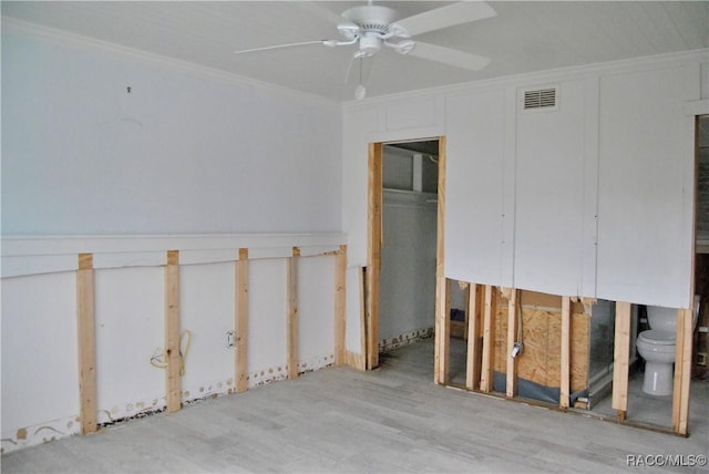 interior space with ceiling fan and ornamental molding