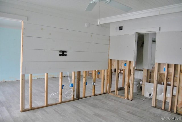 misc room featuring ceiling fan, ornamental molding, and wood-type flooring