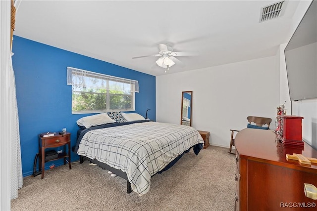 bedroom with baseboards, ceiling fan, carpet flooring, and visible vents