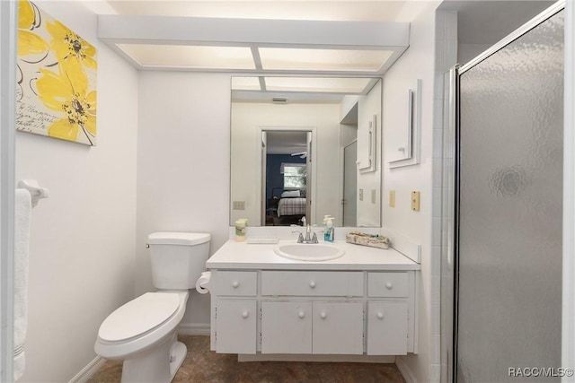 ensuite bathroom featuring connected bathroom, vanity, toilet, baseboards, and a stall shower