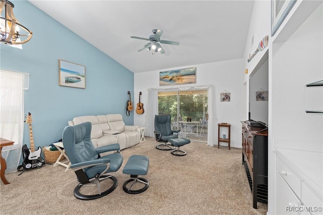 living room with carpet, ceiling fan with notable chandelier, and vaulted ceiling