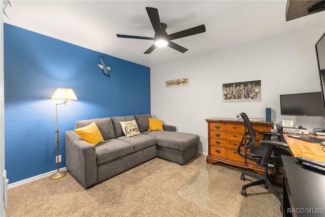 office area with carpet floors, ceiling fan, and baseboards