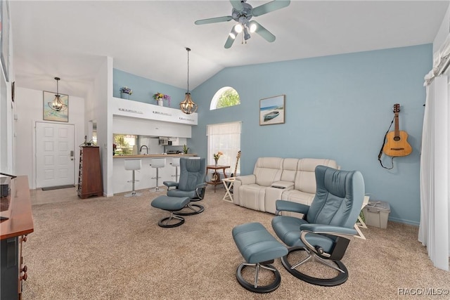 carpeted living room featuring a ceiling fan and high vaulted ceiling