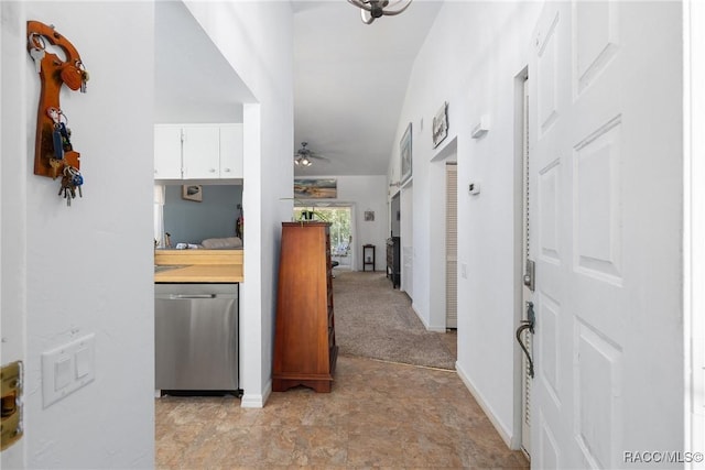 hallway with baseboards and stone finish flooring