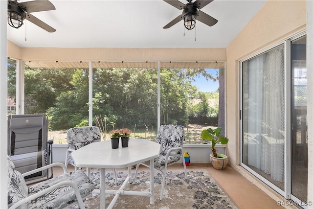 sunroom / solarium featuring ceiling fan and outdoor dining area
