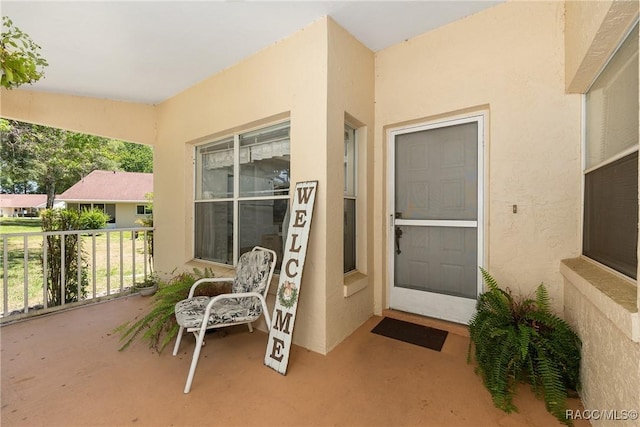 property entrance featuring stucco siding
