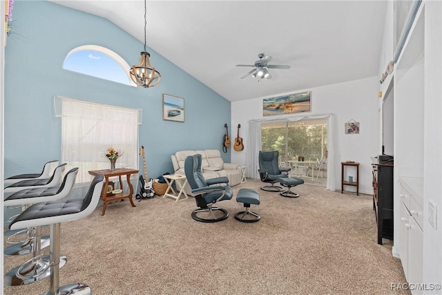 sitting room featuring carpet, ceiling fan with notable chandelier, and high vaulted ceiling