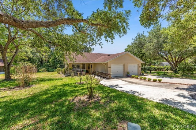 ranch-style home with an attached garage, concrete driveway, a porch, and a front yard