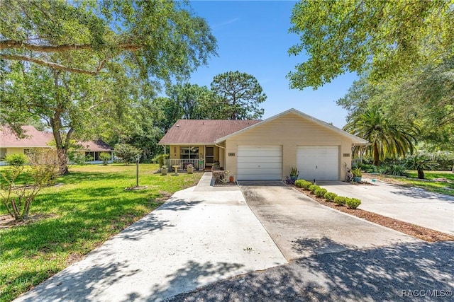 ranch-style house featuring an attached garage, driveway, a front yard, and a porch