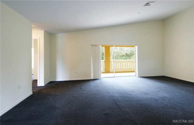 carpeted empty room featuring lofted ceiling